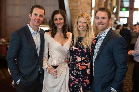Colt McCoy and his wife in right pose a picture with their friends at their wedding.